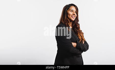 Seitenansicht der jungen Geschäftsfrau vor weißem Hintergrund und weg schauen. Portrait von lächelnden Geschäftsfrau in gold-braune Haare. Stockfoto