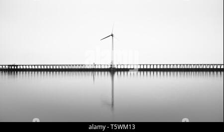 Kein Sonnenaufgang an diesem Morgen an Blyth Pier, aber die Küste wurde durch dichten Nebel, die für einige atmosphärische suchen B&W auf Windkraftanlagen umgeben Stockfoto