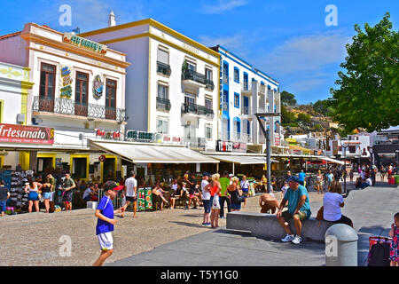 Lebendige Szene als Touristen genießen zu Fuß durch und erkunden Sie die Geschäfte, Bars und Restaurants in den Straßen der Altstadt von alburfeira. Stockfoto