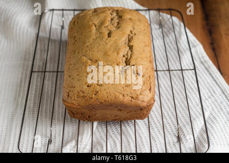 Banana Bread Loaf auf Kuchen Grid - Ganze Bananenkuchen mit selektiven Fokus Stockfoto