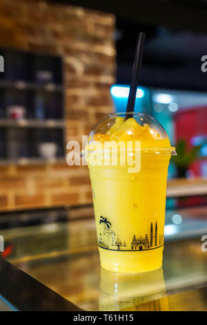 Mango Sorbet Smoothie in der nehmen Sie Schale aus Kunststoff., Thailand. Stockfoto