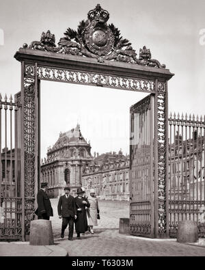 1920er Jahre GUARD BEOBACHTEN VIER anonymen Touristen gehen durch das SCHMIEDEEISERNE EINGANGSTOR DES SCHLOSSES VON VERSAILLES FRANKREICH - r 1164 HAR 001 HARS FREUDE LIFESTYLE GESCHICHTE FEIER FRAUEN LUXUS IN VOLLER LÄNGE DAMEN PERSONEN INSPIRATION MÄNNER B&W ZEIT TRÄUME GLÜCK ABENTEUER DISCOVERY GATES REISE UND URLAUB ÄUSSERE FÜHRUNG VERZIERTEN ERHOLUNG DIE FEIERTAGE BERUFE PALACE TOURISTEN KONZEPTIONELLE STILVOLLE BESUCH Mitte - Mitte - erwachsenen Mann Mitte der erwachsenen Frau ENTSPANNUNG ZWEISAMKEIT FERIEN 17.Jahrhundert 18.Jahrhundert schwarze und weiße KAUKASISCHEN ETHNIE CHATEAU HAR 001 ALTMODISCH TOURING Stockfoto