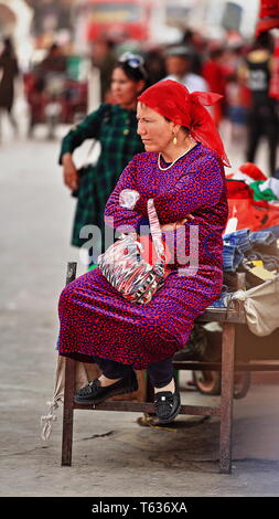 Verkäuferin im mittleren Alter von Uyghur, die auf dem Sonntagsmarkt der Stadt sitzt. Hotan-Xinjiang-China-0100 Stockfoto