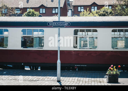 Sheringham, Großbritannien - 21 April, 2019: Station name Zeichen auf einem Bahnsteig in Sheringham. Die Mohnblume Linie Zug, ein Erbe Steam Railway, die von Sh läuft Stockfoto