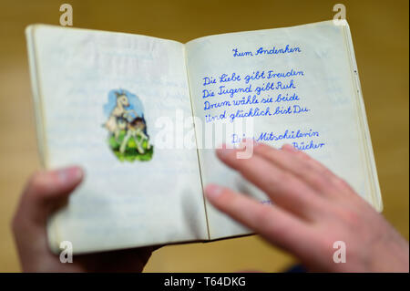 Oldenburg, Deutschland. 11 Apr, 2019. Stefan Walter, wissenschaftlicher Mitarbeiter am Institut für Pädagogik an der Carl-von-Ossietzky-Universität Oldenburg, schaut sich ein Poesie Album. Walter hat recherchiert und seine Dissertation über Poesie Alben geschrieben. Credit: mohssen Assanimoghaddam/dpa/Alamy leben Nachrichten Stockfoto