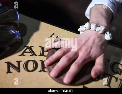 Berlin, Deutschland. 24 Apr, 2019. Der Schauspieler Alex van Ric (als Medium) mit einem Ouija Brett an der Berliner Dungeon. Die show éance - Haben Sie Ihr das Gefühl auch?" geht es um ein Medium, das versucht, den Geist einer Frau während einer Nekromantie zu zaubern. Quelle: Britta Pedersen/dpa-Zentralbild/ZB/dpa/Alamy leben Nachrichten Stockfoto