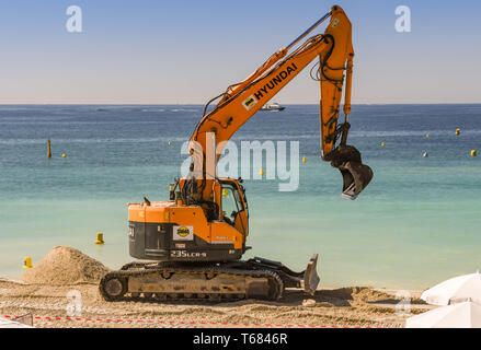 CANNES, Frankreich - April 2019: Bagger Hinzufügen neuer Sand am Strand in Cannes für den Frühling und Sommer Saison bereit Stockfoto