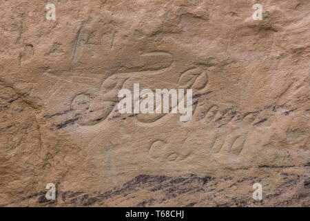 Spanisch Inschriften in eleganten Skript entlang der Inschrift Rock Trail in El Morro National Monument, New Mexico, USA gesehen Stockfoto