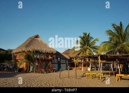 Strohgedeckte Bungalows für Touristen Unterkünfte am Strand Chacahua, Oaxaca, Mexiko. Apr 2019 Stockfoto