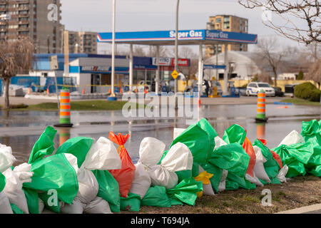 Pierrefonds-Roxboro, Quebec, Kanada - 29 April 2019: Street im Frühjahr Hochwasser überschwemmt, mit Sandsäcken in der foregroung. Stockfoto