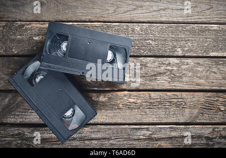 Zwei Kunststoff Video Kassetten aus den 80er Jahren auf einem rustikalen Holztisch. Ansicht von oben. Stockfoto