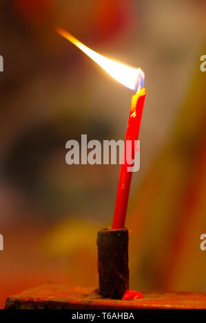 Gebet-rot Brennen lange Kerzen in Budist temple Stockfoto
