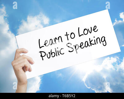 Liebe Sprechen in der Öffentlichkeit Zeichen auf weißem Papier erfahren. Mann Hand, Papier mit Text. Auf Himmel Hintergrund isoliert Stockfoto