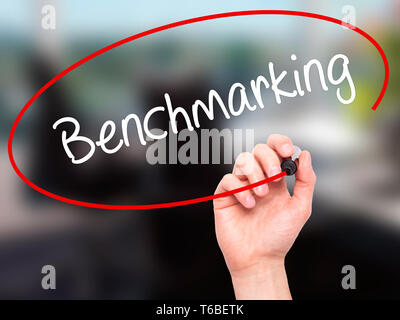 Mann Hand schreiben Benchmarking mit schwarzem Marker auf visuelle Bildschirm Stockfoto