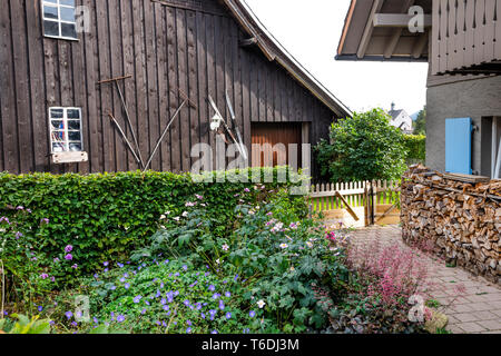 Bauerngarten mit Holzstapel im Hochschwarzwald, Menzenschwand, Deutschland, ländlichen Garten von typischen Schwarzwälder Landhäuser Stockfoto