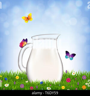 Kanne mit Milch und Gras und Blumen Stockfoto