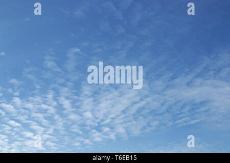 Blauer Himmelshintergrund mit winzigen Wolken Stockfoto