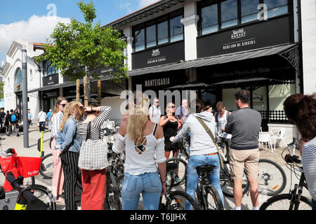 Junge Menschen mit Fahrradverleih Fahrräder und Tour Guide außerhalb der Zeit, essen Markt Gebäude Eingang Ribeira Lissabon Lisboa Portugal Europa EU-KATHY DEWITT Stockfoto