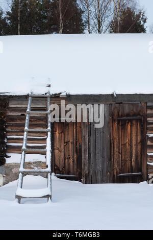 Log Building in Natturi Dorf im Winter Stockfoto