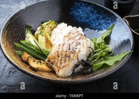 Moderne japanische Frittierter Kabeljau Filet mit bok Choi und Reis in der Ansicht von oben in eine Schüssel geben. Stockfoto