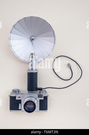 Retro analoge Foto Kamera mit Blitz, auf der Leinwand im Hintergrund. Stockfoto