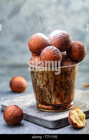 Hüttenkäse Donuts in einem alten Eimer. Stockfoto