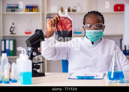 Junge schwarze Chemiker im Labor arbeiten Stockfoto