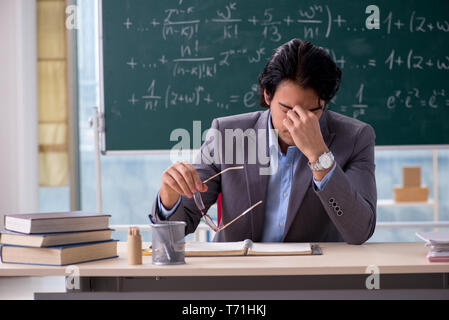 Junge schöne Mathematik Lehrer im Klassenzimmer Stockfoto