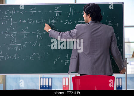 Junge schöne Mathematik Lehrer im Klassenzimmer Stockfoto