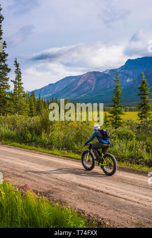 Ein Mann fett Radfahren auf dem nabesna Road in Wrangell-St. Elias National Park an einem bewölkten Sommertag im Süden - zentrales Alaska Stockfoto