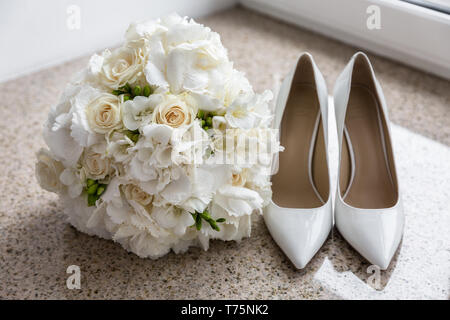 Wedding Bouquet neben Schuhe der Braut Stockfoto