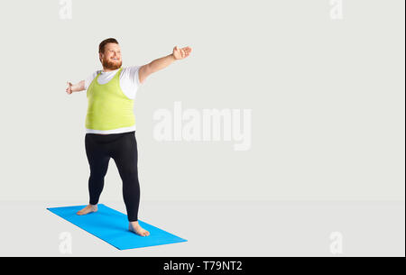 Fett lustige Mann Yoga auf grauem Hintergrund Stockfoto