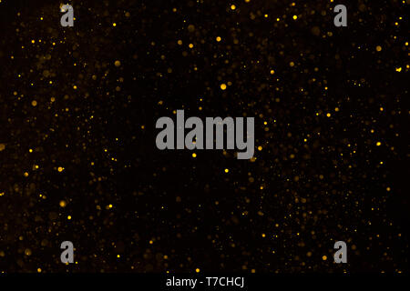 Golden Glitter, Glitzer Hintergrund auf Schwarz Stockfoto