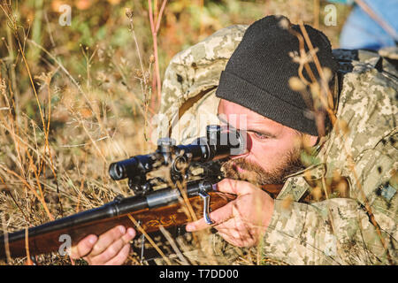 Jagd Fähigkeiten und Waffen Ausrüstung. Wie schalten Sie die Jagd in Hobby. Bärtiger Mann Jäger. Die Streitkräfte. Camouflage. Uniform Mode. Mann Jäger mit Gewehr Pistole. Boot Camp. Armee Soldaten. Stockfoto