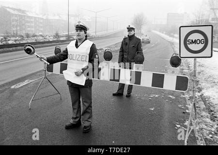 Essen, Deutschland, 18. Januar 1985. Smog Alarm im Ruhrgebiet. Autofahrer auf der B1 in die Stadt Essen dürfen nicht in die Stadt zu fahren. In der Bundesrepublik Deutschland zum ersten Mal Smog Alarm der Stufe III genannt wird. Vor allem das westliche Ruhrgebiet ist betroffen. Stufe III der Smog Verordnung verhängt ein absolutes Fahrverbot privaten Autos. - - - Essen, 18. Januar 1985. Smog-Alarm im Ruhrgebiet. Autofarher auf der B 1 im Stadtgebiet Essen dürfen nicht in die Stadt fahren. In der Bundesrepublik wird machen Smog-Alarm der Stufe III ausgerufen. Betroffen ist vor allem das Westli Stockfoto