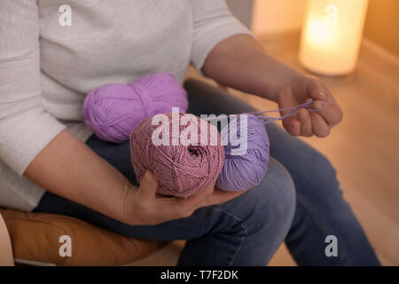 Reife Frau die Wahl der Farbe des Strickens Gewinde innen Stockfoto