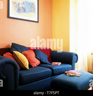 Blau gepolsterten Hocker und Sofa mit bunten Kissen Stockfoto