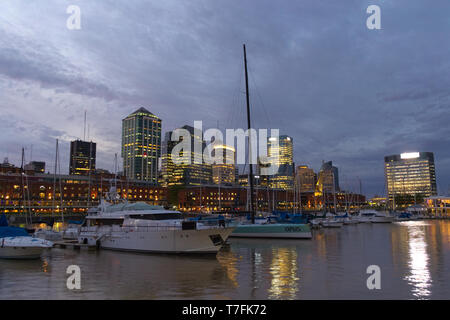 Mehrere Yachten in Puerto Madero verankert, in der Stadt Buenos Aires, in der Dämmerung. Stockfoto