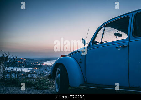 Vintage Käfer Auto bei Sonnenuntergang, einen Road Trip tausendjährigen zu machen Stockfoto