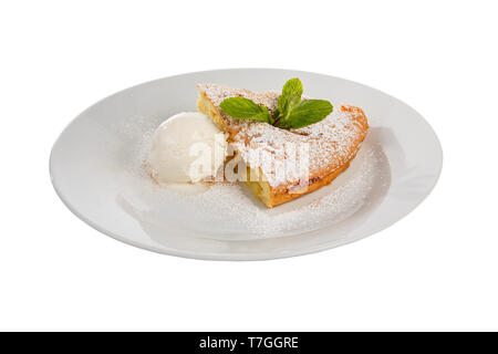 Apfelkuchen, Charlotte mit Vanilleeis, Puderzucker und Minzeblatt, serviert auf einem Teller isoliert weißer Hintergrund. Dessert für ein Menü in einem Cafe, Res Stockfoto