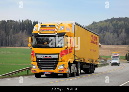 Salo, Finnland - 26 April 2019: Gelb DAF XF480 FTG Lkw der Kuljetusliike Humalamaki Ky zieht DHL Trailer im Straßenverkehr im Süden Finnlands. Stockfoto