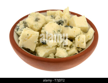 Seitliche Sicht auf eine kleine Schüssel mit Chunks von Blauschimmelkäse auf einem weißen Hintergrund. Stockfoto