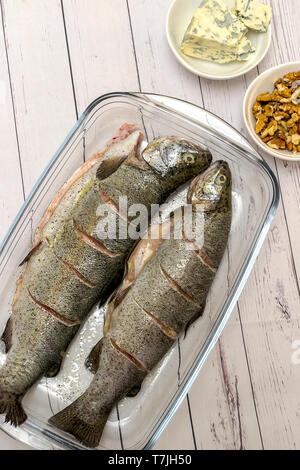 Gebratene Forelle mit Gemüse Walnüsse und Blauschimmelkäse - bevor sie bereit Stockfoto