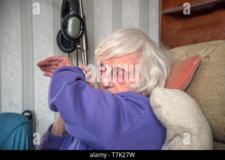 Ein blinder 90 Jahre alte Dame, mit schweren Makuladegeneration de-Generation kann nur die Zeit es sagen hören mit ihr zu sprechen. Stockfoto