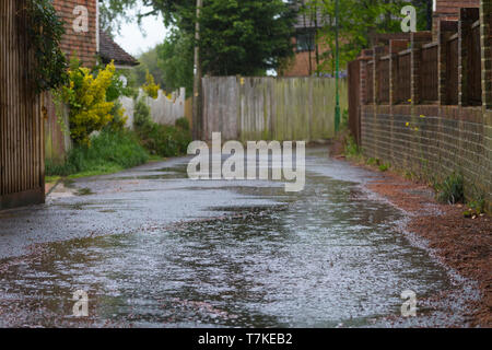 Ashford, Kent, Großbritannien. 8. Mai, 2019. UK Wetter: Die Aussichten für den Tag ist heavy rain mit maximalen Temperaturen von 12 °C, helleres Wetter wird später an diesem Abend erwartet. Ein Postmitarbeiter geht über sein Geschäft die Briefzustellung trotz der schrecklichen Bedingungen. © Paul Lawrenson 2019, Foto: Paul Lawrenson/Alamy leben Nachrichten Stockfoto