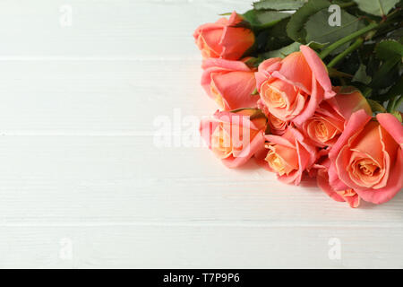 Strauß frischer Rosen auf hölzernen Hintergrund, Nahaufnahme Stockfoto