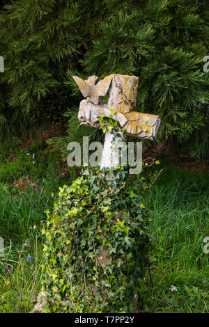 Grab Kreuz bewachsen in St. Peters Kirche Friedhof, in dem Dorf Dunchurch, Warwickshire, West Midlands, England. Das Gras wird links zu wachsen Stockfoto