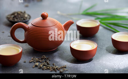 Grüner Tee, Teekanne und Schüsseln, Tassen auf schiefer Hintergrund. Close Up. Stockfoto