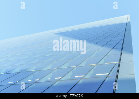 Abstrakte moderne Architektur Fragment, Ecke von Wänden aus glänzendem Glas und Stahl unter blauem Himmel Stockfoto