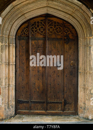 C 15 Eingang S Kirchenschiff von St. Saeran's Kirche, Llanynys, Denbighshire, Wales, UK: original verzierte Holztür mit eisenplatte Heiligtum Ring. Stockfoto